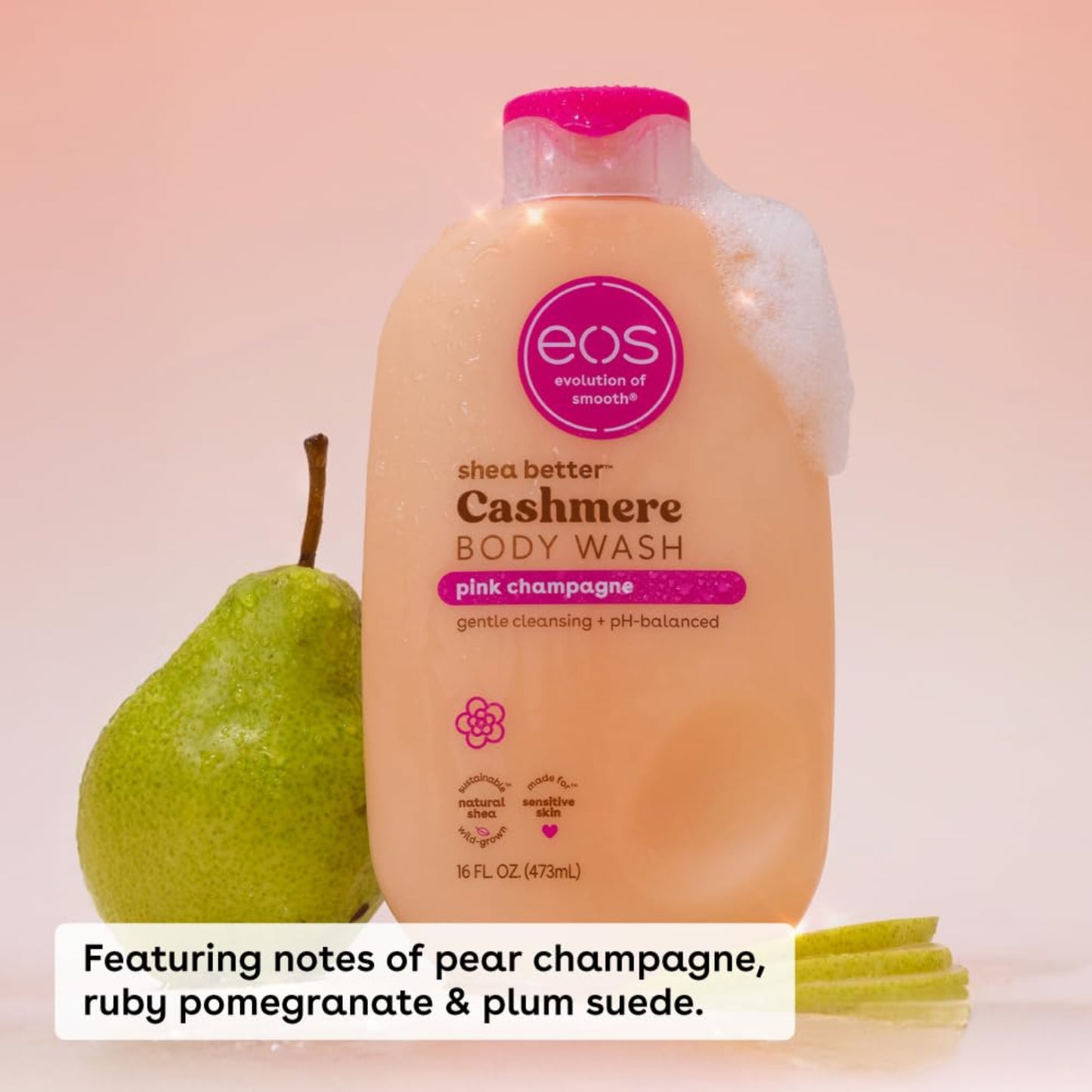 EOS Cashmere Body Wash bottle with a green pear on a pink background