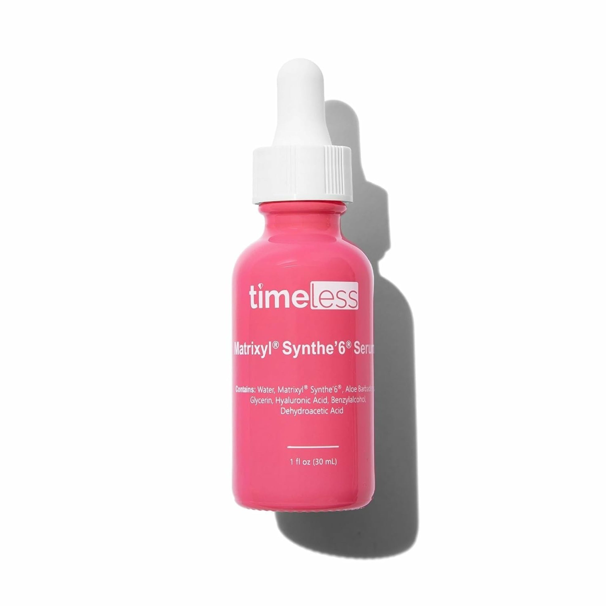 Pink serum bottle with white cap on a white background