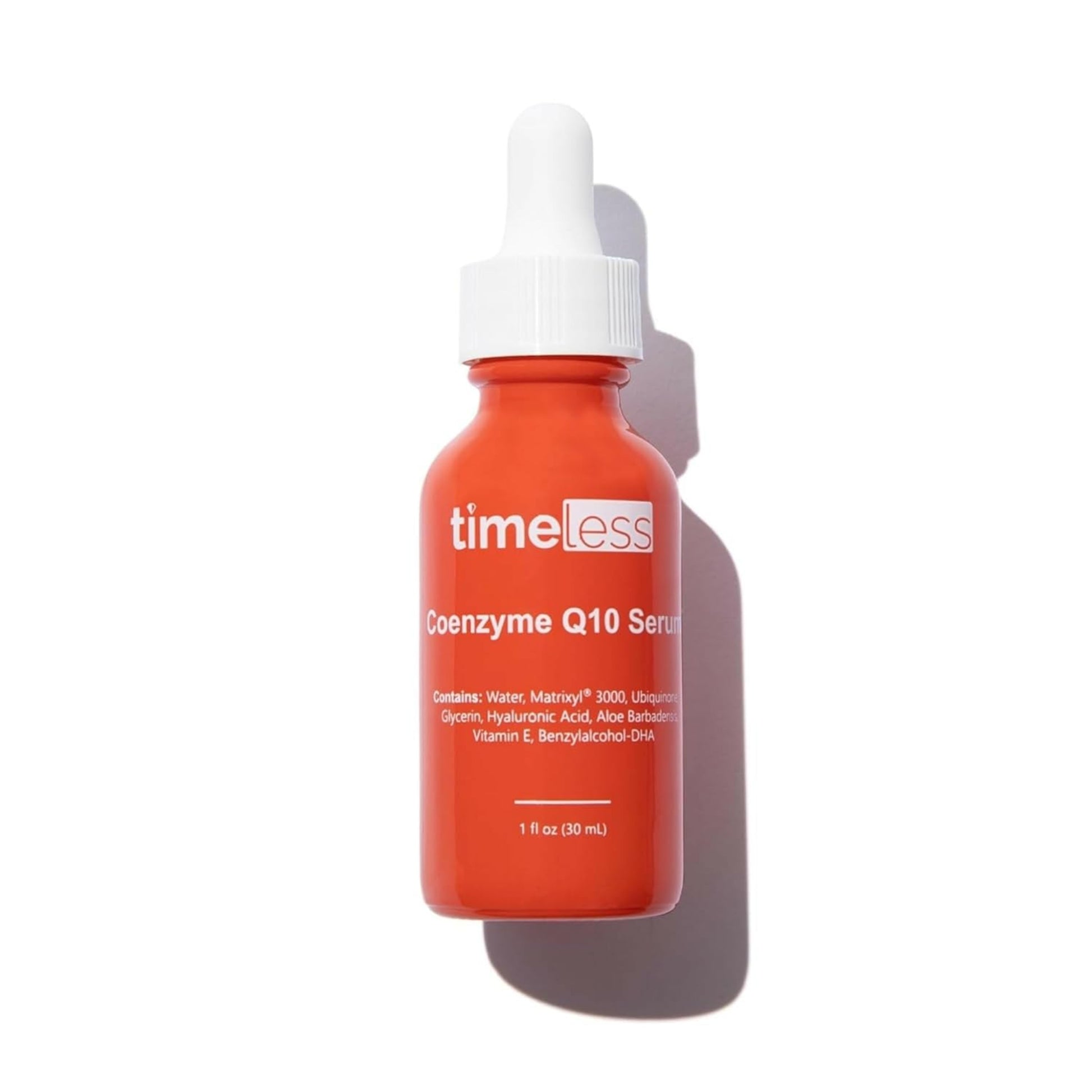 Red serum bottle with dropper labeled 'timeless' on a white background