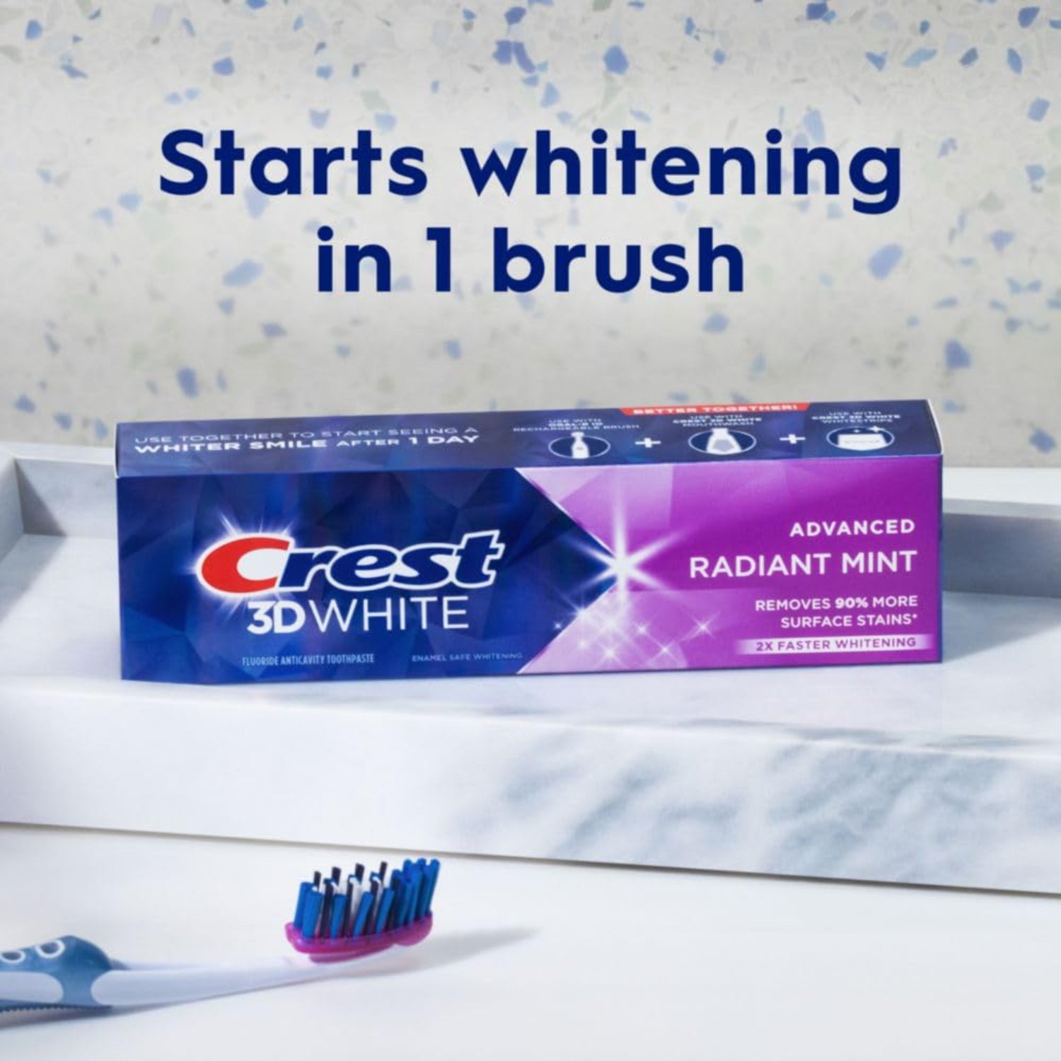 Crest 3D White toothpaste tube with a toothbrush on a speckled background