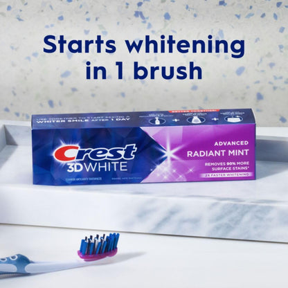 Crest 3D White toothpaste tube with a toothbrush on a speckled background