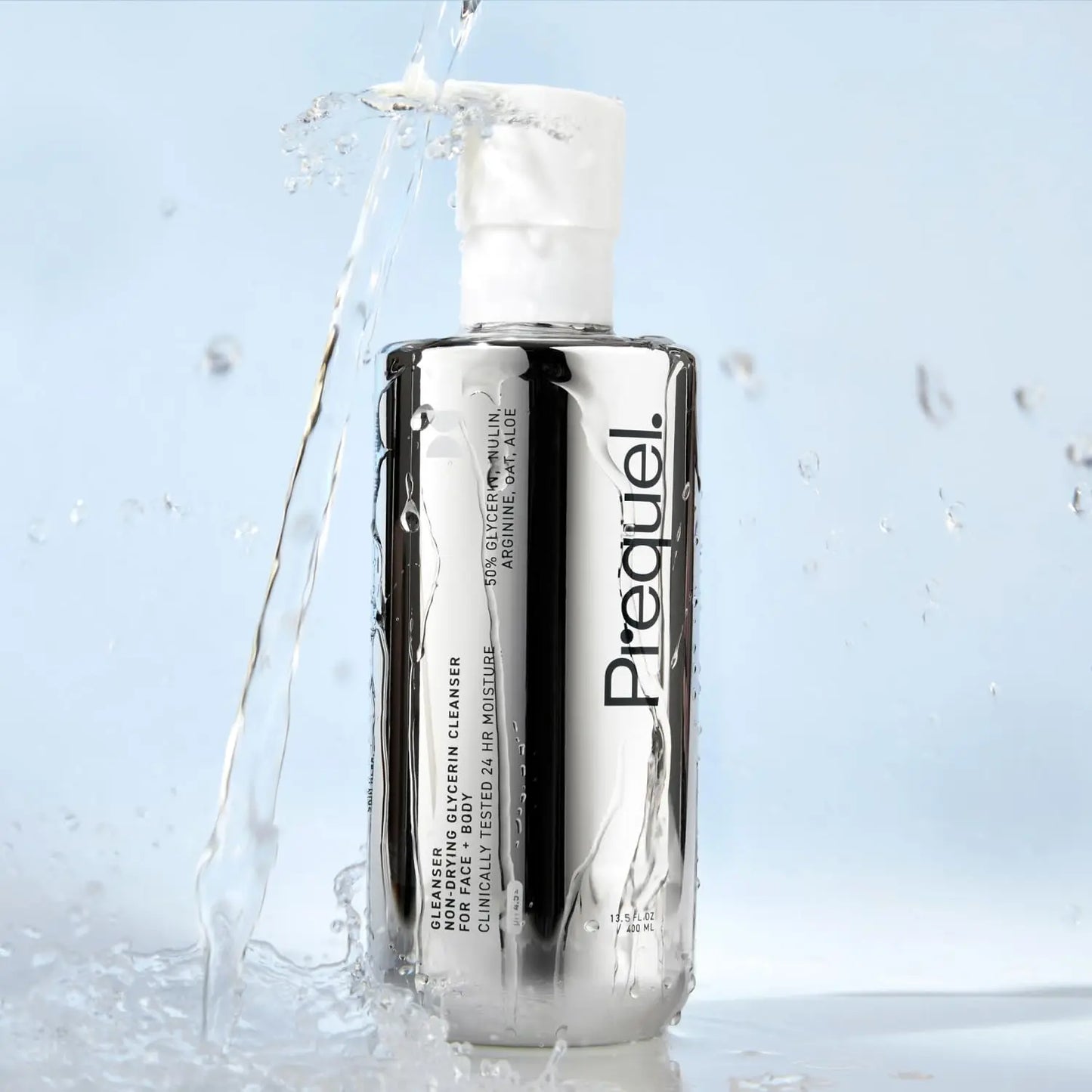 Bottle of Prequel cleanser with water splashes on a light blue background