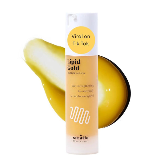 Stratia Lipid Gold lotion with a droplet of lotion on a white background