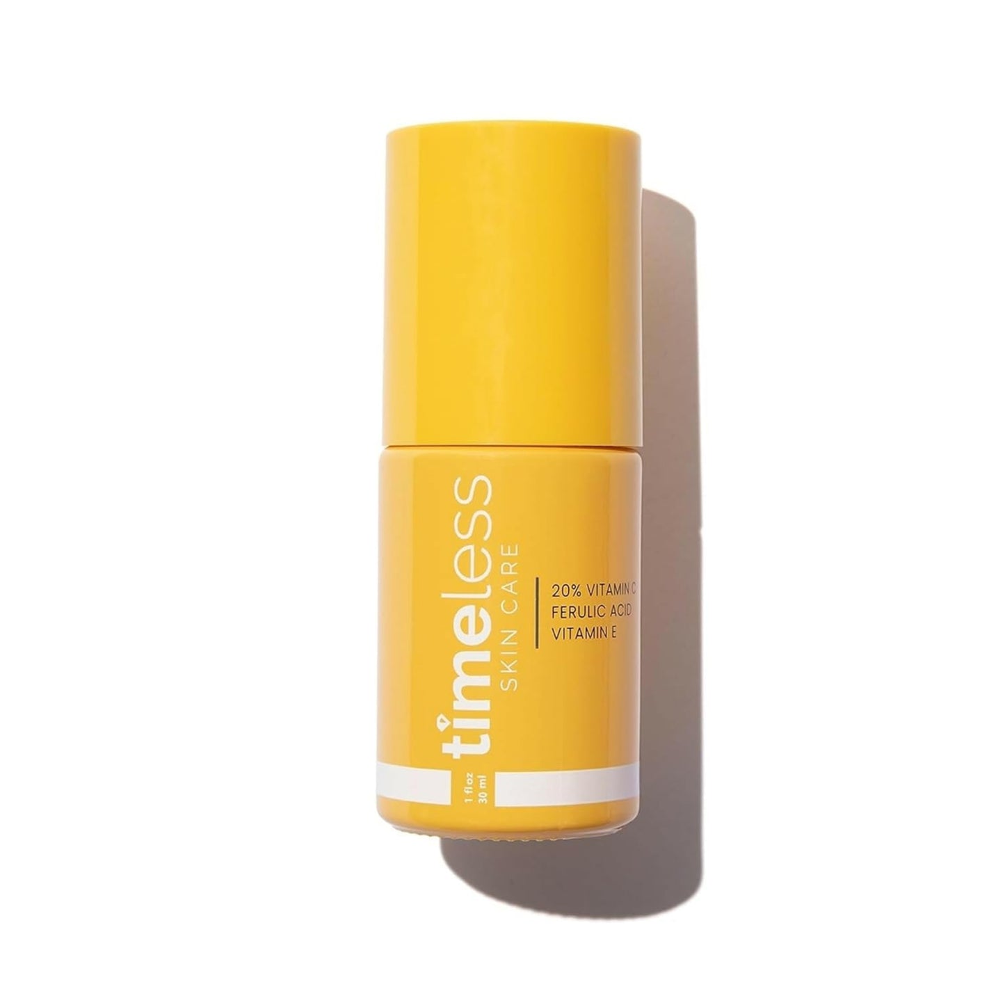 Yellow skincare bottle labeled 'timeless' on a white background