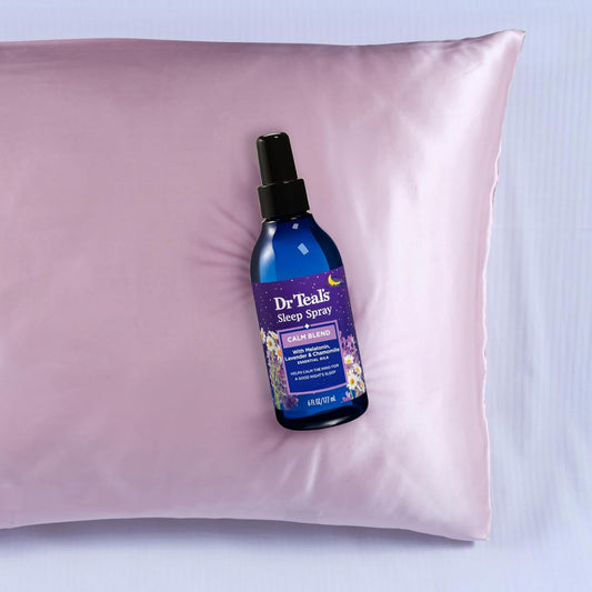 Dr. Teal's Sleep Spray bottle on a pink pillow with a light purple background