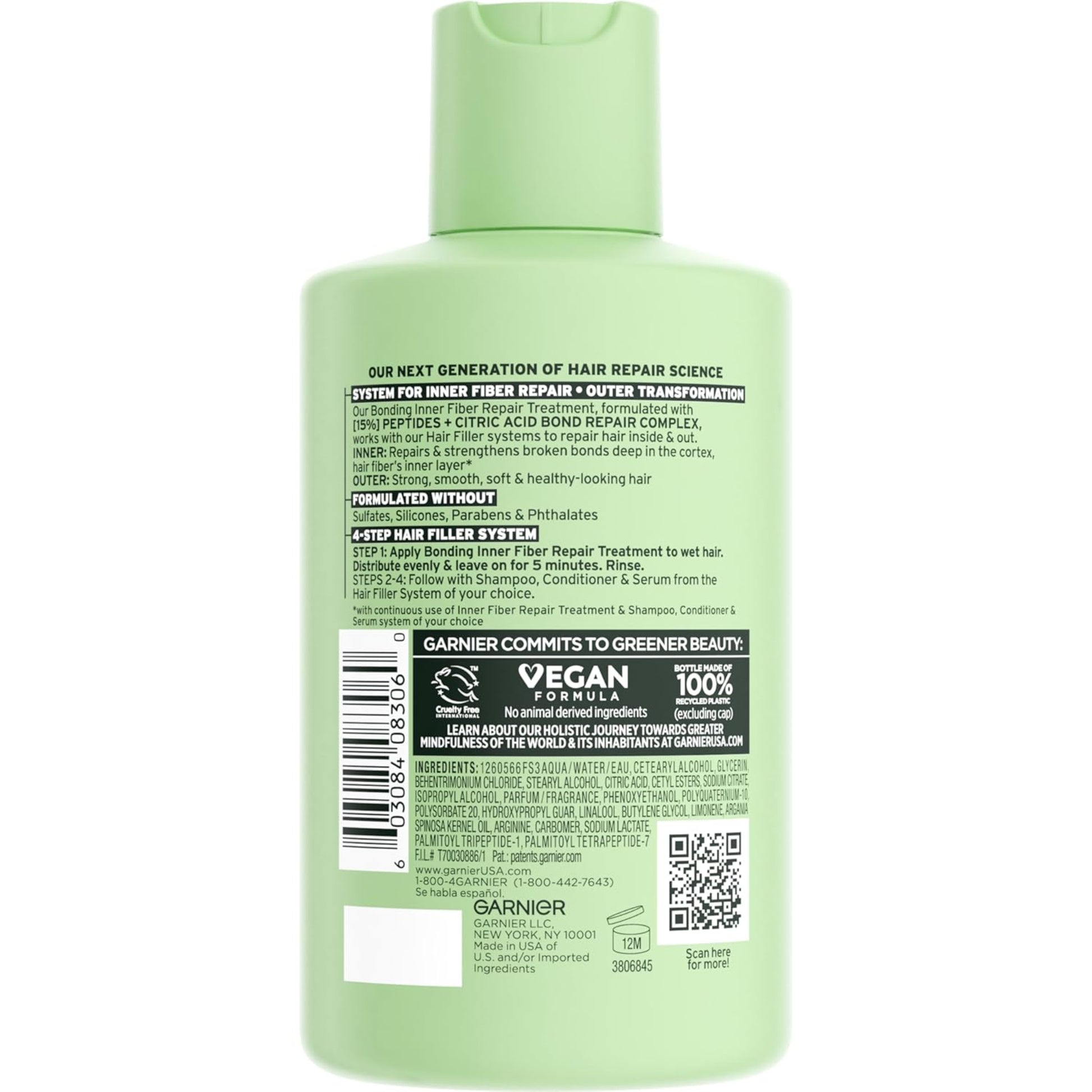 Green hair care product bottle with label on a white background