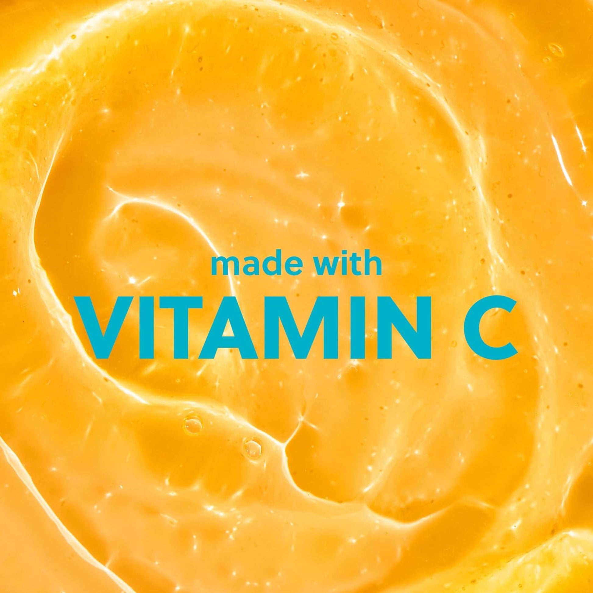 Close-up of orange-colored substance with 'made with VITAMIN C' text overlay