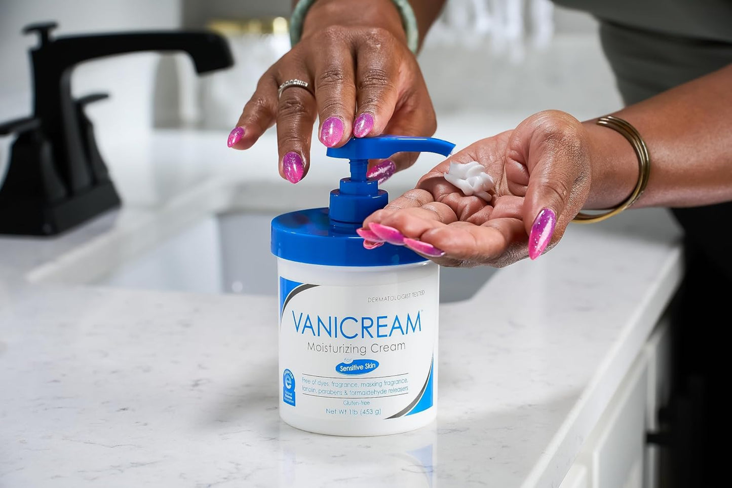 Person using Vanicream moisturizing cream on a white countertop.