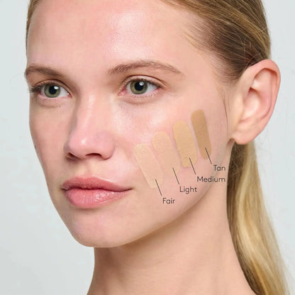 Woman's face with color swatches labeled from Light to Tan to Medium on a neutral background