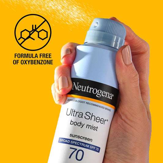 A hand holding a bottle of NEUTROGENA Ultra Sheer Body Mist Sunscreen with SPF 70. The label indicates the product is formula free, organic, and made in Canada.