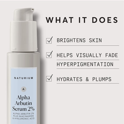 Naturium Alpha Arbutin Serum bottle with text highlighting its benefits on a light gray background