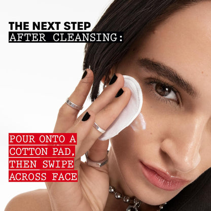 Woman applying a product to her face with text about cleansing steps.