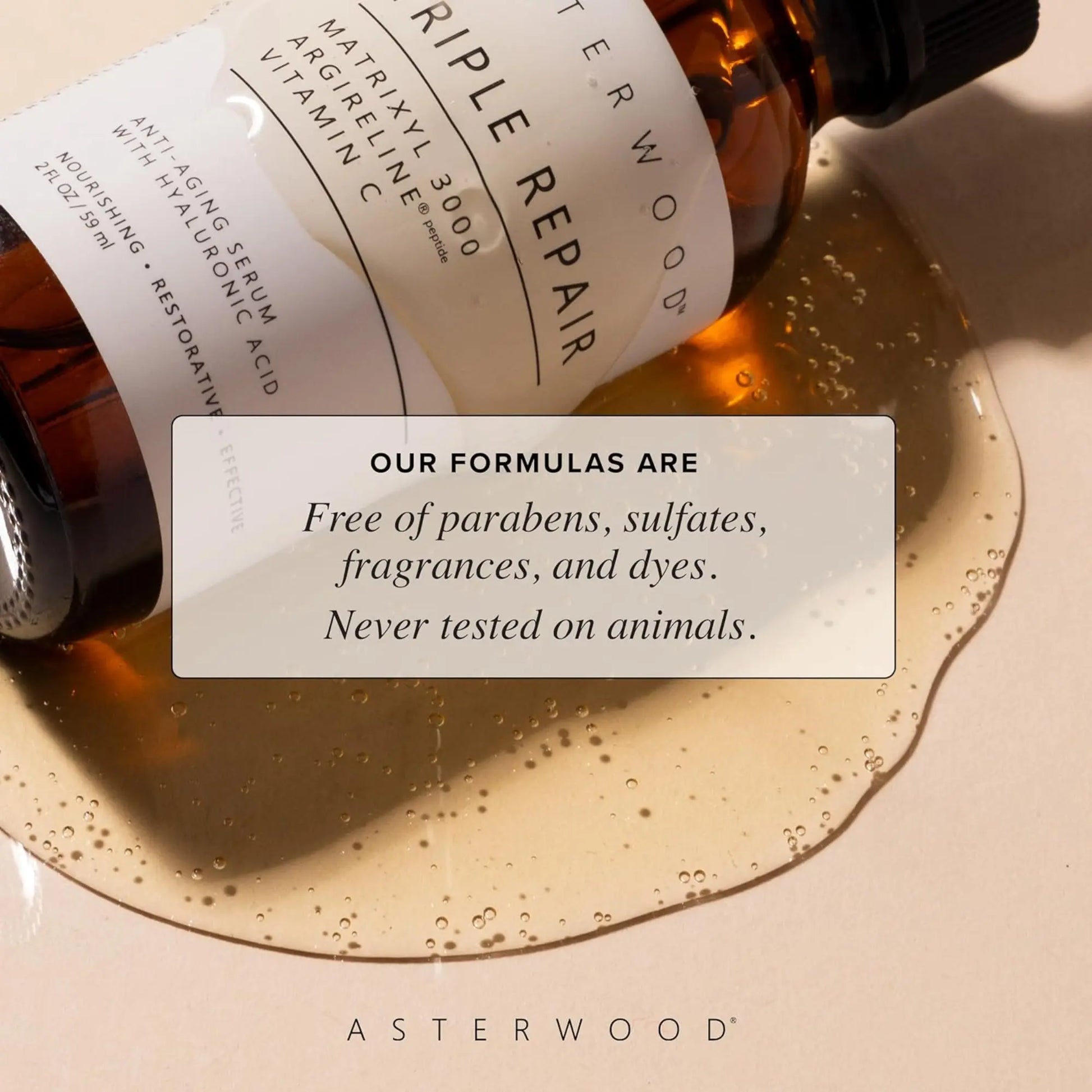 A bottle of Asterwood skincare serum with a label and a droplet of serum on a beige background.