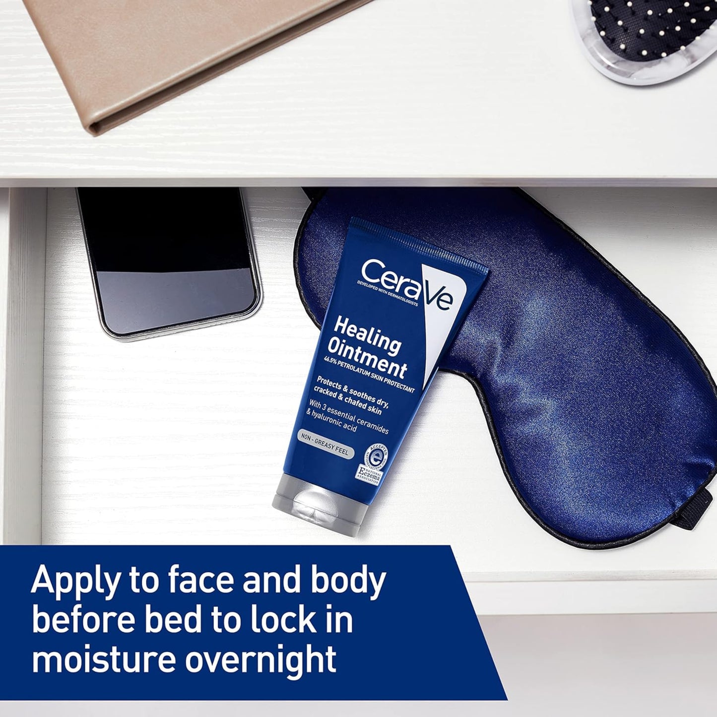 CeraVe Healing Ointment tube with a sleep mask on a desk