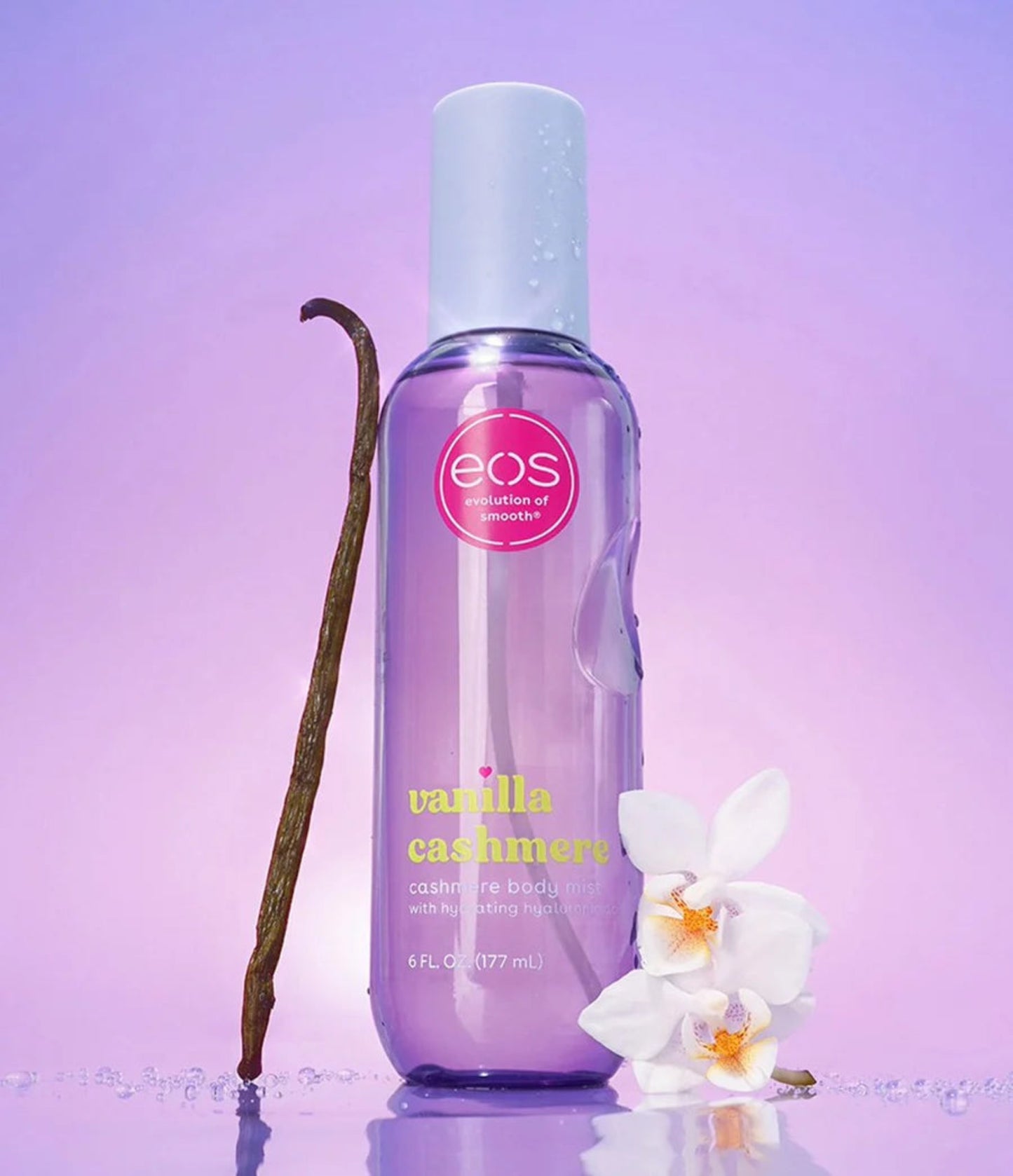 EOS Vanilla Cashmere body spray bottle with vanilla bean and orchid on a purple background