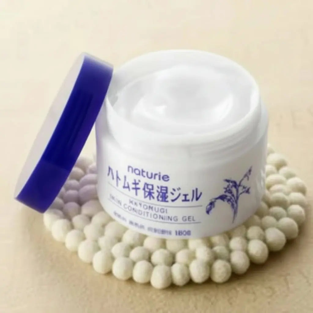 Jar of cream with a purple lid on a beige background