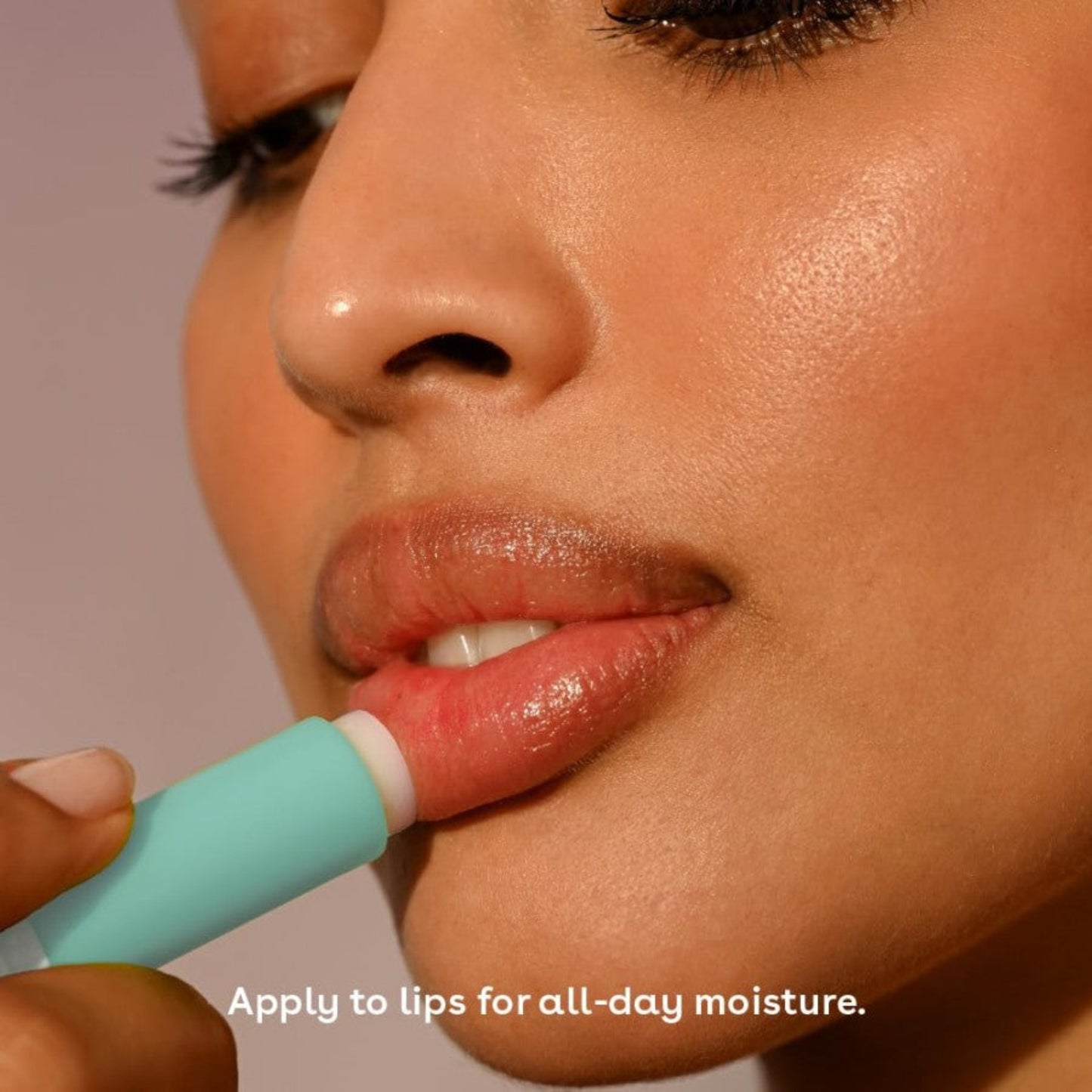 Person applying lip balm with a focus on lips and text about lip care.